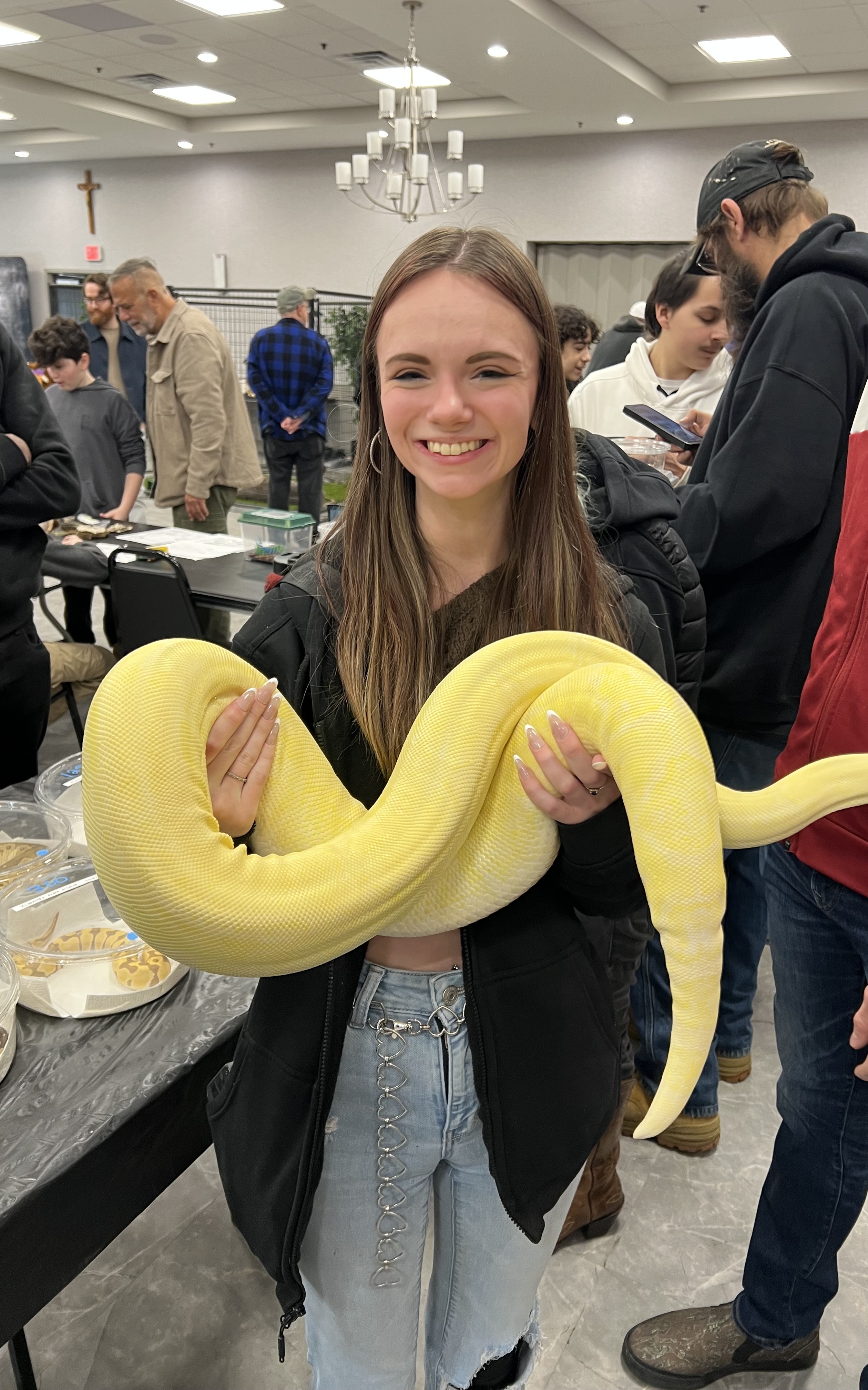 Abby holding a large yellow python at a reptile show